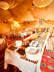 a long table with a toilet in a tent at Eco Merzouga luxury camp in Merzouga