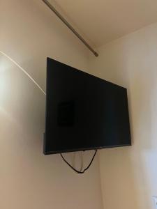 a flat screen tv hanging on a wall at Studio cabine près de la plage in Le Lavandou +1 photo