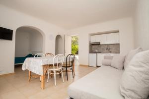 a living room with a table and a couch at Residence Palummera in Forio d'Ischia