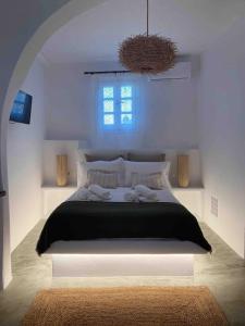 a bedroom with a large bed with a window at Agreli House in Lichnaftia