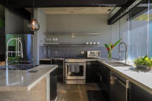 a kitchen with a stove and a sink at Entre Lomas Boutique in Montezuma +19 photos