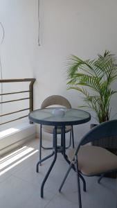 a blue table and a chair and a plant at Elegante, hermoso, equipado en Villeta in Villeta +15 photos