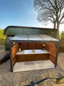 an outdoor bath tub in the back of an rv at Theddlethorpe Horsebox Glamping in Theddlethorpe Saint Helen