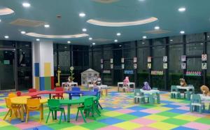 a rendering of a classroom with colorful tables and chairs at Loft and Luxe 1BR Condo in Clark in Fort Stotsenburg