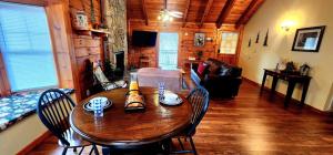 a dining room with a wooden table and chairs at Country Romance - Peaceful Getaway in Jones Cove