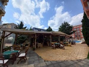 a patio with tables and chairs and a pavilion at Rainbow 2 studio 7 in Sunny Beach