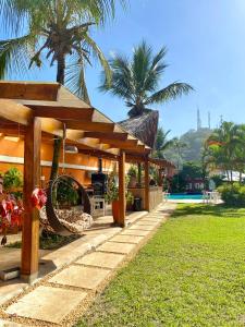 a resort with a wooden pavilion and a pool at Pousada Dolce Vita in Itanhaém +39 photos