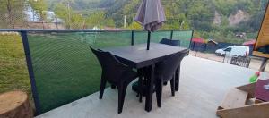 an umbrella sitting on top of a table on a balcony at Aframe GG la Casa Galeata in Jeţu