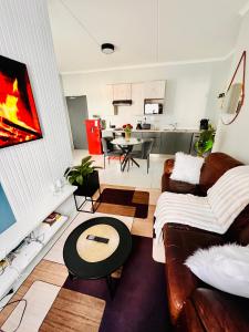 a living room with a couch and a table at Stunning 1 bed in Midrand at 93 On New Estate in Midrand