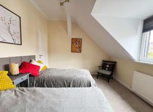 a bedroom with two beds and a desk and a window at Big Premium Apartment with Rhine View, totally new in Duisburg