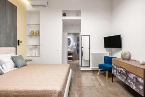 a bedroom with a bed and a tv in a room at Casta Diva Fervore Apartments Self Check-in in Palermo