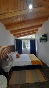 a bedroom with a large bed with a window at Casa nouă in Vişeu de Sus