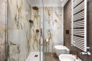 a bathroom with a toilet and a glass shower at Casta Diva Fervore Apartments Self Check-in in Palermo +24 photos