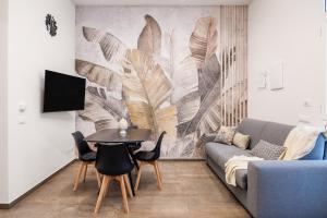 a living room with a couch and a table at Casta Diva Fervore Apartments Self Check-in in Palermo