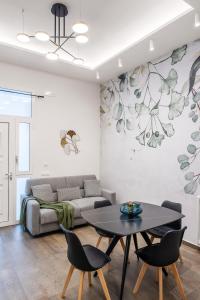 a living room with a couch and a table at Casta Diva Fervore Apartments Self Check-in in Palermo