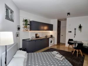 a bedroom with a bed and a kitchen with a table at Paradise Garden Sweet Studio in Limassol
