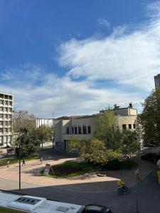 a building with people walking in front of it at Japandi Home in Niš