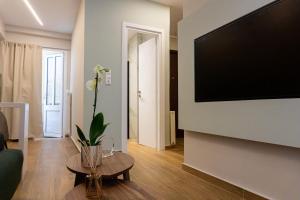 a living room with a large flat screen tv on a wall at Elegant Suite - Piraeus in Piraeus