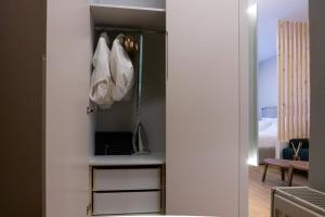 a room with white shoes hanging on a wall at Elegant Suite - Piraeus in Piraeus