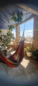 a hammock is hanging from a tent in a patio at Portais São Thomé casa de temporada in São Thomé das Letras