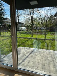 a sliding glass door with a view of a yard at Apartament nad Nilem in Kolbuszowa