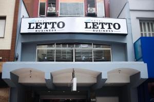 a building with a sign for a lobota business at Letto Business in Porto Alegre