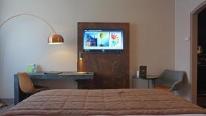 a bedroom with a bed and a tv on a wall at Martin's Brussels EU in Brussels