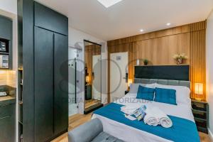 a bedroom with a large bed with blue pillows at Studio Lido - 802 Reformado em POA in Porto Alegre +158 photos