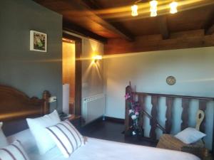 a bedroom with a bed and a chair in it at Apartamento La Corrada in Santa Eulalia de Oscos