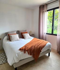 a white bedroom with a large bed with a window at Villa Bali, magnifique vue mer et Esterel in Saint-Aygulf