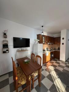 a kitchen with a table and chairs and a refrigerator at Rocks View Apartment in Durrës