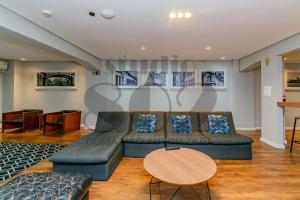 a living room with a couch and a table at Studio Lido - 802 Reformado em POA in Porto Alegre