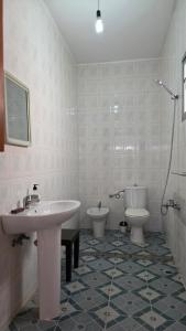 a bathroom with a sink and a toilet at casa belyounech in Belyounech 