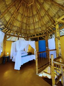 Ένα ή περισσότερα κρεβάτια σε δωμάτιο στο Minca Ecohabs Hotel