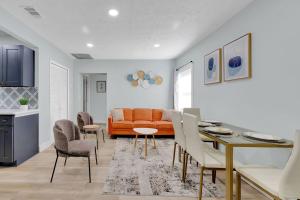 a living room with a couch and a table and chairs at SMV Updated Bungalow Bliss Central in Jacksonville