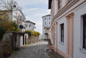 an alley in a city with buildings at Fürstenhof Sassnitz in Sassnitz