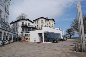 a store in a street with two tall buildings at Fürstenhof Sassnitz in Sassnitz