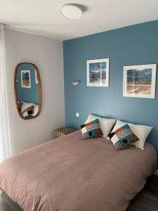 a bedroom with a large bed with a mirror at Appartement T4 à 200m de la plage in Saint-Jean-de-Luz +10 photos