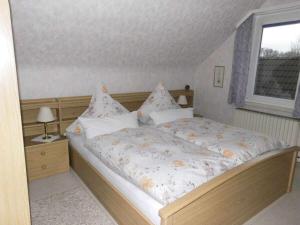a large bed in a bedroom with a window at Holiday apartment with 2 bedrooms in Bad Harzburg
