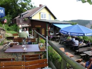 a group of people sitting at tables in front of a building at Holiday apartment with 2 bedrooms in Bad Harzburg