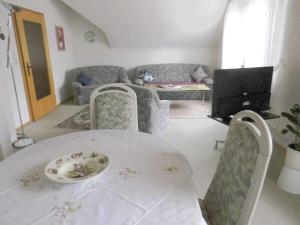 a living room with a table and chairs and a couch at Holiday apartment with 2 bedrooms in Bad Harzburg
