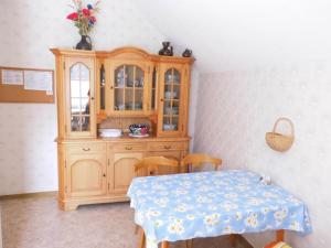 a wooden cabinet with a table in a room at Holiday apartment with 2 bedrooms in Bad Harzburg