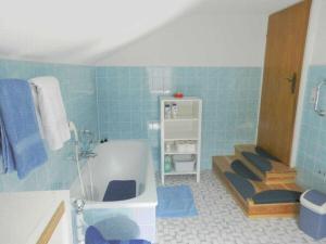 a blue bathroom with a tub and a sink at Holiday apartment with 2 bedrooms in Bad Harzburg +12 photos