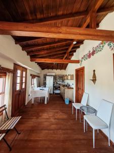 a living room with wooden ceilings and a table and chairs at Villa Hera Doğanbey in Doğanbey