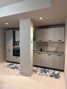 a kitchen with stainless steel cabinets and a sink at Ca' Monte 2 - Dimora Centrale 2 camere in Montebelluna