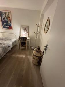 a bedroom with a bed and a table with a cross at Cozy Room in Great Location Stockwell Clapham in London