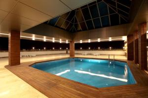 a large swimming pool in a building at Grand Hotel Gaziantep in Gaziantep