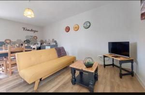 a living room with a couch and a table at Gite Vigne - stay on a vineyard, overlooking the vines in this 2 bedroomed gite in Savigné
