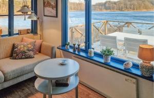 a living room with a couch and a table at Amazing Home In Perstorp With Sauna in Perstorp