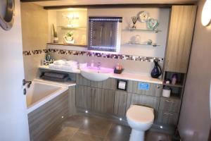 a bathroom with a sink and a toilet at The Dairy at Brackenthwaite Farm in Carnforth +33 photos